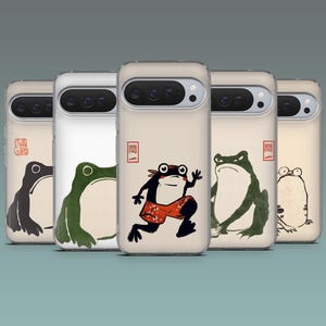 May include: A collection of five phone cases featuring whimsical frog illustrations in various poses. Each case has a beige background with a different frog design in black and green, with a red stamp and Japanese text.