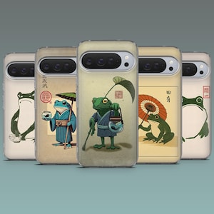 May include: A collection of phone cases featuring Japanese-inspired frog illustrations. Each case showcases a different frog design, including frogs with umbrellas, carrying items, and in various poses. The cases have a clear, protective design.
