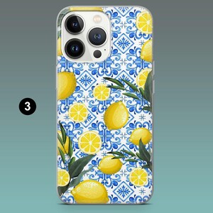 May include: A clear phone case featuring a vibrant design of yellow lemons, lemon slices, and green leaves on a white and blue tile pattern. The case is designed for a smartphone.