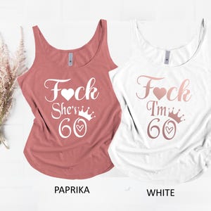 May include: Two sleeveless tank tops, one paprika and one white. Each top has the text "F*ck I'm 60" with a heart and crown graphic. The bottom of the paprika tank top reads "PAPRIKA" and the white tank top reads "WHITE".