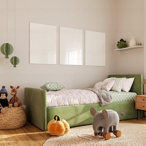 May include: A green upholstered daybed with a white and green patterned duvet and pillows. There are two framed pictures on the wall behind the bed. A wicker basket with stuffed animals sits on the floor next to the bed. A gray elephant toy with wooden wheels sits on a rug in front of the bed.