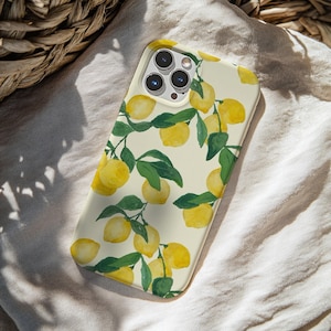 May include: A phone case featuring a watercolor design of lemons and green leaves on a cream background. The case has a glossy finish and is designed to fit a smartphone. The lemon pattern is repeated across the surface.