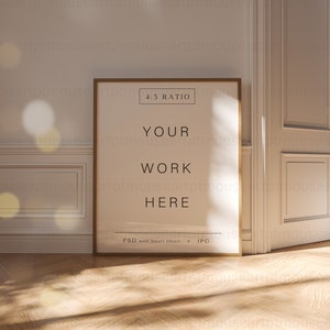 May include: A gold framed poster mockup with the text "4:5 RATIO", "YOUR WORK HERE", and "PSD with Smart Object + JPG" on a white background. The poster is leaning against a white wall with a white door to the right. The floor is a light brown wood.