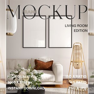 May include: Mockup of two black picture frames hanging on a white wall in a living room setting. The frames are empty and ready for your design. The room features a white sofa with a brown throw pillow, a white vase with white and green flowers, and a tall, woven floor lamp.