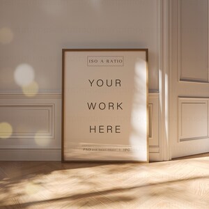 May include: A gold framed poster mockup with the text "ISO A RATIO", "YOUR WORK HERE", and "PSD with Smart Object + JPG" on a white background. The poster is leaning against a white wall with white trim and a white door.
