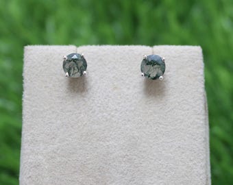 May include: A pair of silver stud earrings with round green moss agate stones.