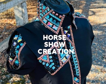 May include: Black show shirt with a teal and rose gold rhinestone design. The shirt has a collar and short sleeves. The text "HORSE SHOW CREATION" is printed on the front of the shirt.