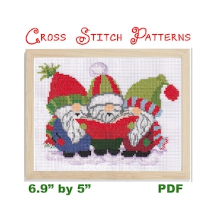 May include: Cross stitch pattern featuring three gnomes singing Christmas carols. The gnomes are wearing red, green, and blue hats and scarves. The pattern is 6.9 inches by 5 inches and is available as a PDF download.