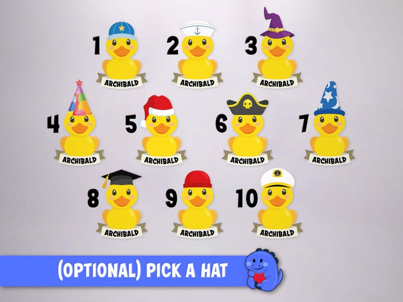 May include: Ten yellow rubber ducks arranged in rows, each wearing a different hat and featuring a banner below with the name ARCHIBALD. The hats include a baseball cap, sailor hat, wizard hat, party hat, Santa hat, pirate hat, and graduation cap.