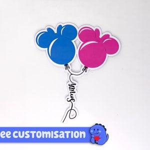 Pode incluir: Dois bal&otilde;es em forma de Mickey Mouse, um azul e outro rosa, amarrados com um cord&atilde;o que diz "Smith".