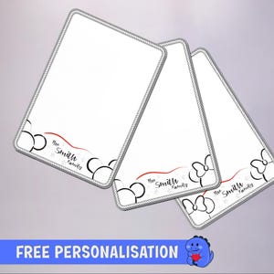 May include: Three rectangular white cards with a gray rope-style border. Each card features a black outline of mouse ears, a red wavy line, and the text "The Smith Family" in black script. The cards are arranged in a slightly overlapping fan pattern.