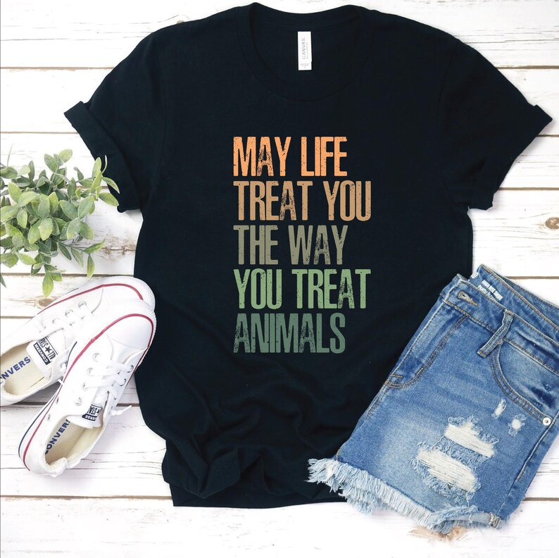May include: Black t-shirt with a vintage-style graphic that reads "May life treat you the way you treat animals".