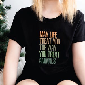 May include: Black t-shirt with a vintage-style graphic that reads "May life treat you the way you treat animals".