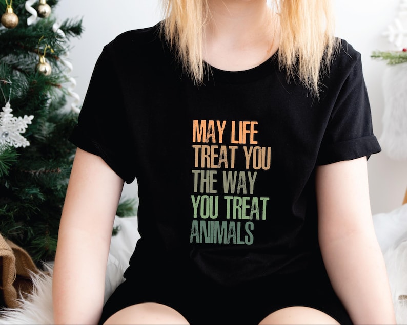 May include: Black t-shirt with a vintage-style graphic that reads "May life treat you the way you treat animals".