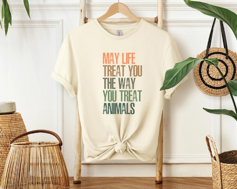 Make a statement with the "May Life Treat You The Way You Treat Animals" shirt—perfect for animal lovers, activists, and those who believe in kindness and justice. This powerful design is a reminder to treat all living beings with compassion. Whether you're an advocate for animal rights or simply want to spread a message of empathy, this t-shirt is a meaningful addition to your wardrobe. Soft, comfortable, and stylish, it also makes a great gift for fellow animal lovers and activists.