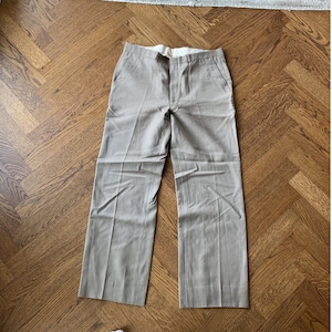 May include: A pair of light brown wide-leg pants with a straight leg.