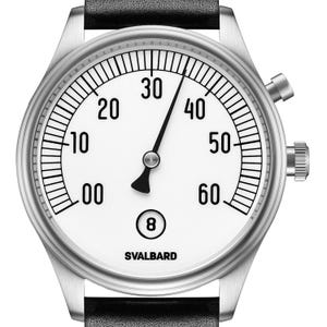 May include: A silver-toned wristwatch with a white face, black hands, and a black leather band. The watch face features black numerals and markers, with the brand name "SVALBARD" at the bottom. The watch has two side buttons.