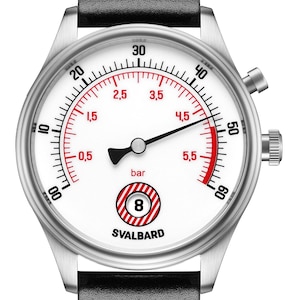 May include: A silver-toned wristwatch with a white face and black leather band. The watch face features red and black markings, including the word "bar" and the number "8" inside a target symbol. The brand name "SVALBARD" is also visible.