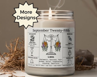May include: A lit candle in a glass jar with a label featuring Libra zodiac symbols and the text "September Twenty-Fifth." The candle is white, with a wisp of smoke rising. The label includes astrological glyphs and characteristics.