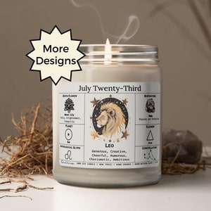 May include: A white candle with a glass jar and a black and gold label. The label has the text "July Twenty-Third" and "Leo" with astrological symbols and information about the zodiac sign.