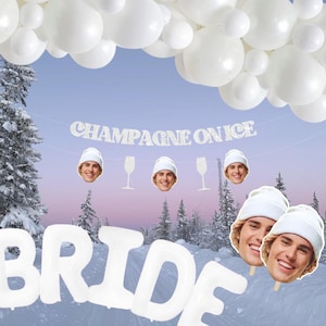 May include: White and silver 'BRIDE' balloons with a white and silver 'Champagne on Ice' banner. There are also white balloons in the background and a few white and silver face cutouts with a winter theme.