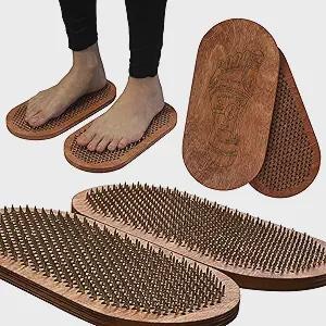 May include: Wooden sadhu boards with nails. The boards are oval-shaped and made of light brown wood. The nails are evenly spaced across the surface. One pair of boards has feet on them, and another pair is shown separately.