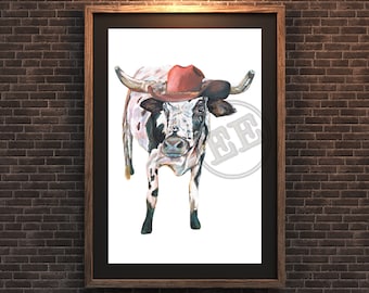 May include: Watercolor painting of a longhorn steer wearing a red cowboy hat. The steer has a white and brown spotted coat and large curved horns. The artwork is framed in a dark wooden frame and hangs on a brick wall.