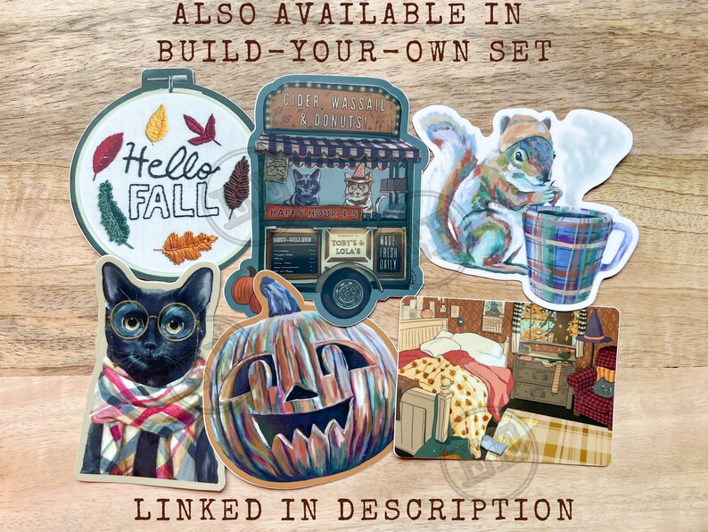 May include: A collection of fall-themed stickers, including a cat wearing glasses and a scarf, a squirrel with a mug, and a pumpkin. The stickers have text that says "Hello Fall" and "Cider, Wassail & Donuts".