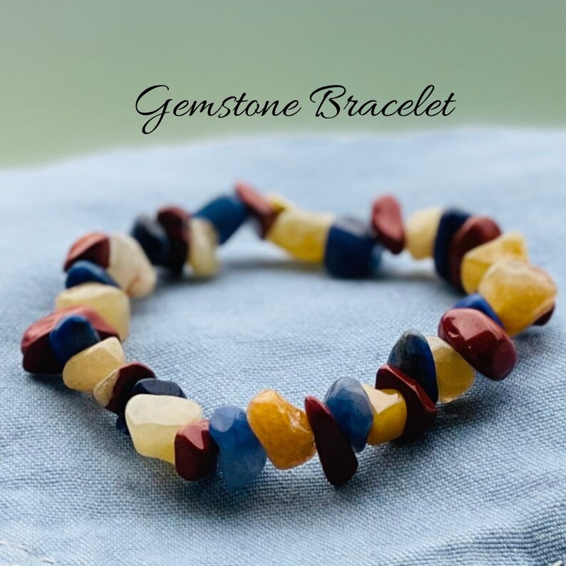 May include: A gemstone bracelet featuring red, yellow, and blue stones. The bracelet is crafted from natural stones and is a beautiful and unique piece of jewellery.