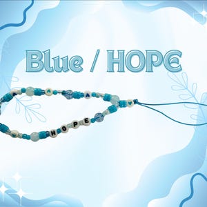 May include: A phone charm featuring blue and white beads, including round beads with the letters H, O, P, E and small heart symbols. The accessory includes a blue cord loop for attachment. The text Blue / HOPE is displayed above the charm.