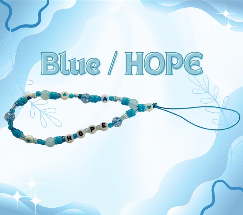 May include: A phone charm featuring blue and white beads, including round beads with the letters H, O, P, E and small heart symbols. The accessory includes a blue cord loop for attachment. The text Blue / HOPE is displayed above the charm.