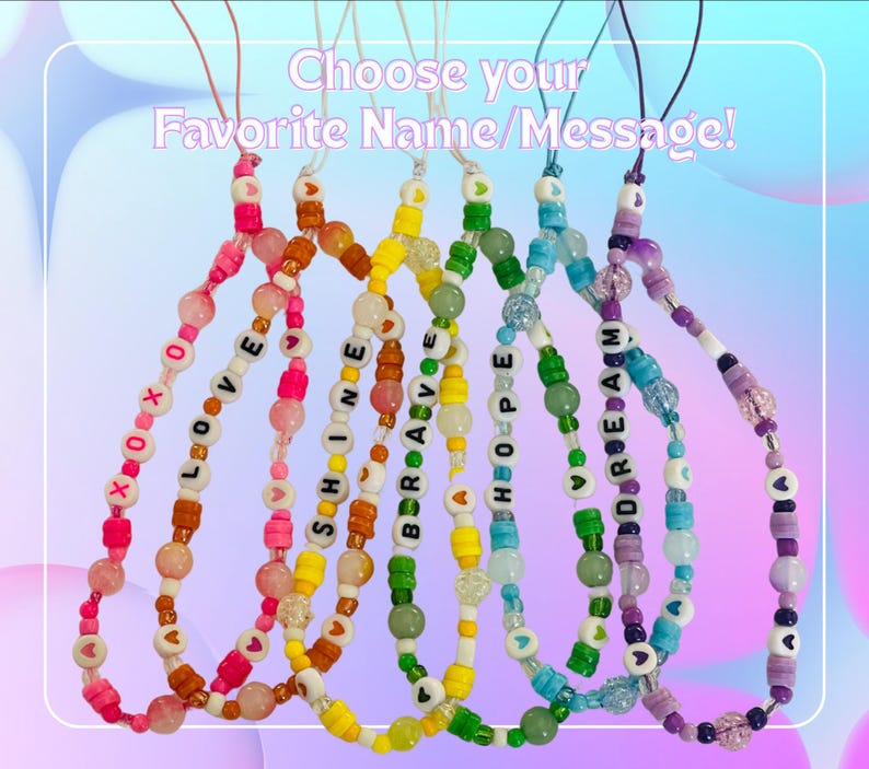 May include: Six colourful beaded phone charms with string loops, featuring letter beads spelling XOXO, LOVE, SHINE, BRAVE, HOPE, and DREAM. The charms include various round, translucent, and heart-shaped beads in pink, orange, yellow, green, blue, and purple.