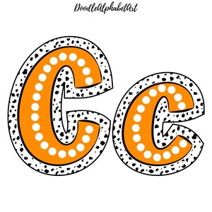 May include: Orange and white letter C with a black and white polka dot pattern. The letter is outlined in black and has a white polka dot border.