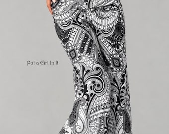 May include: High-waisted flared pants featuring a bold black and white paisley and geometric pattern. The fabric displays intricate swirling motifs and fine line work. The text "Put a Girl In It" is printed on the left side of the garment.