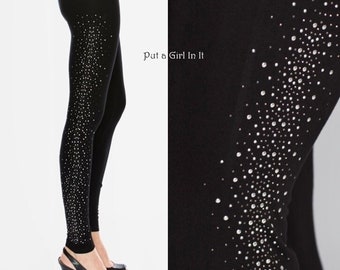 May include: Black leggings with a single line of silver rhinestones down the side. The leggings have the text "Put a Girl In It" printed on the side.