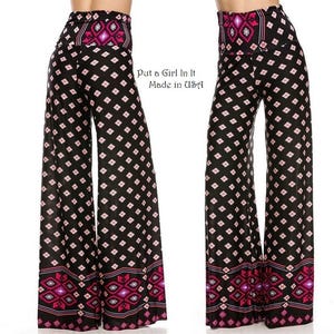 May include: Black and white palazzo pants with a pink and white geometric pattern. The pants have a wide leg and a high waist. The waistband has a pink and white geometric pattern. The text "Put a Girl in It Made in USA" is printed on the pants.