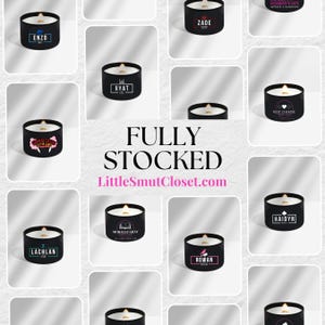 May include: A grid of 12 black candle jars with white text labels. The candles are arranged in a grid pattern on a white background. The text on the labels includes names like Enzo, Zade, Ryat, Why Choose, Lachlan, Morally Gray, Rowan, and Haidyn. The text at the bottom of the image reads "FULLY STOCKED LittleSmutCloset.com".