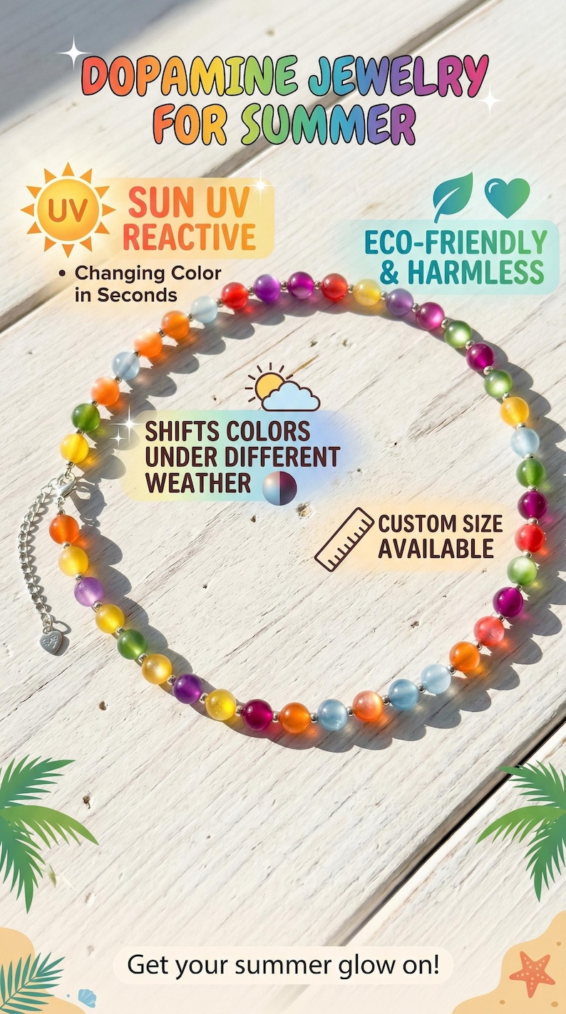 May include: A beaded necklace featuring round, translucent beads in various colors including red, orange, yellow, green, blue, and purple. The necklace includes a silver-toned metal chain extender with a small heart-shaped charm at the end.