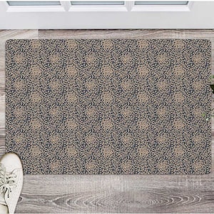 May include: A dark gray doormat with a repeating pattern of beige stylized flowers. The doormat is made of a textured material.