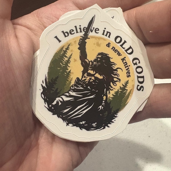 I Believe in Old Gods & New Knives Sticker with Viking Design and Forest Background for Adventure Lovers