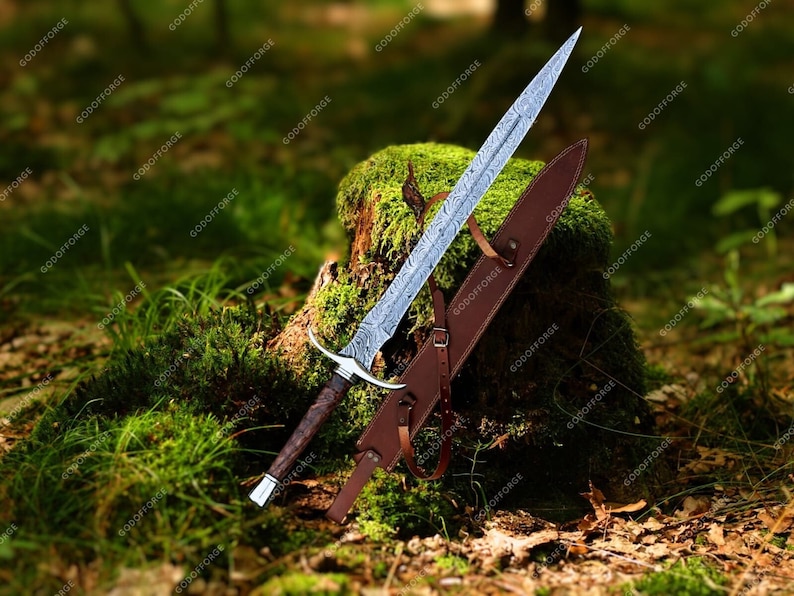 May include: A silver sword with a brown leather scabbard, resting on a mossy tree stump in a forest setting.