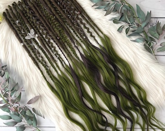 May include: A set of green and brown synthetic dreadlocks with beads and charms. The dreadlocks are wavy and have a natural look.