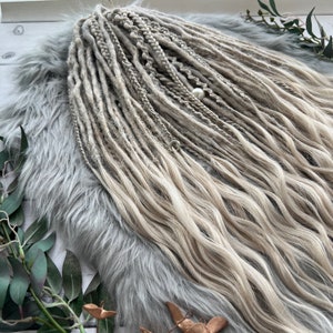 Cool blonde boho de dreads with loose wavy ends in winter style boho chic