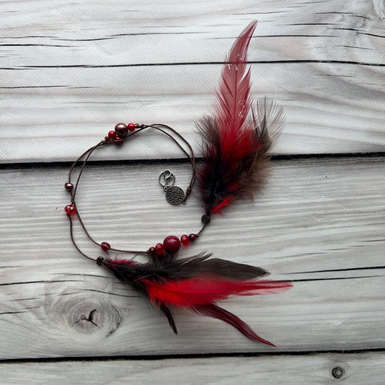 Scarlet Ember – fiery red and brown feather charm for a bold and mystical look. Ideal for adding a pop of color to dreadlocks and braids