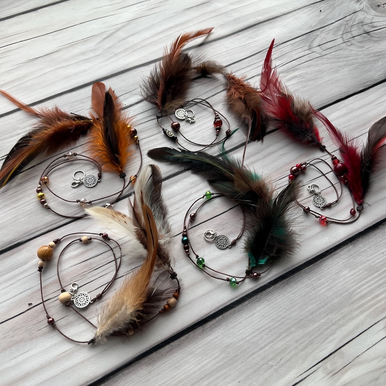 Set of handmade feather hair charms in different colors – perfect for a personalized boho, festival, or Viking-inspired look.