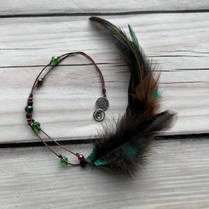Forest Spirit – earthy green and brown feather hair charm with beads. Inspired by nature, perfect for boho and hippie styles.