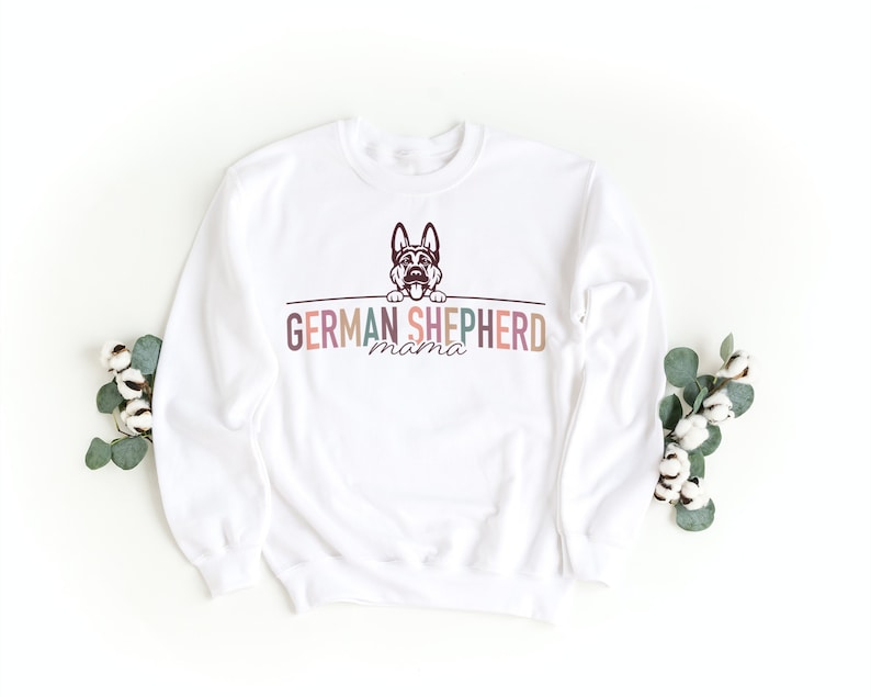 May include: White sweatshirt with a German Shepherd dog graphic and the text "GERMAN SHEPHERD mama" in colorful letters.