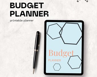 May include: A black tablet displaying a budget planner design with geometric shapes. The words "Budget Planner" are in bold black font, with "printable planner" below. A black pen with gold accents rests beside the tablet. The image is on a textured white surface.