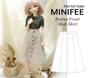 May include: PDF pattern for a button front midi skirt for a doll. The pattern is shown on a doll wearing a green shirt and the skirt. The skirt is beige.