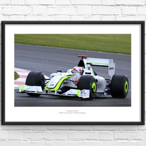 May include: A white and green Formula 1 race car with the number 10 on the side. The car is driven by Jenson Button, the 2009 Formula 1 World Champion.